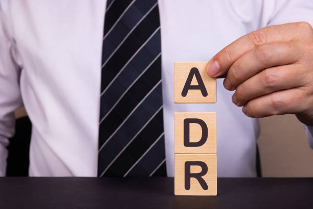 Picture of man holding block letters A, D, and R for alternative dispute resolution