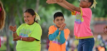 Image of three students attending Kids' Day 2019