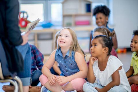 image of two students listening to a teacher